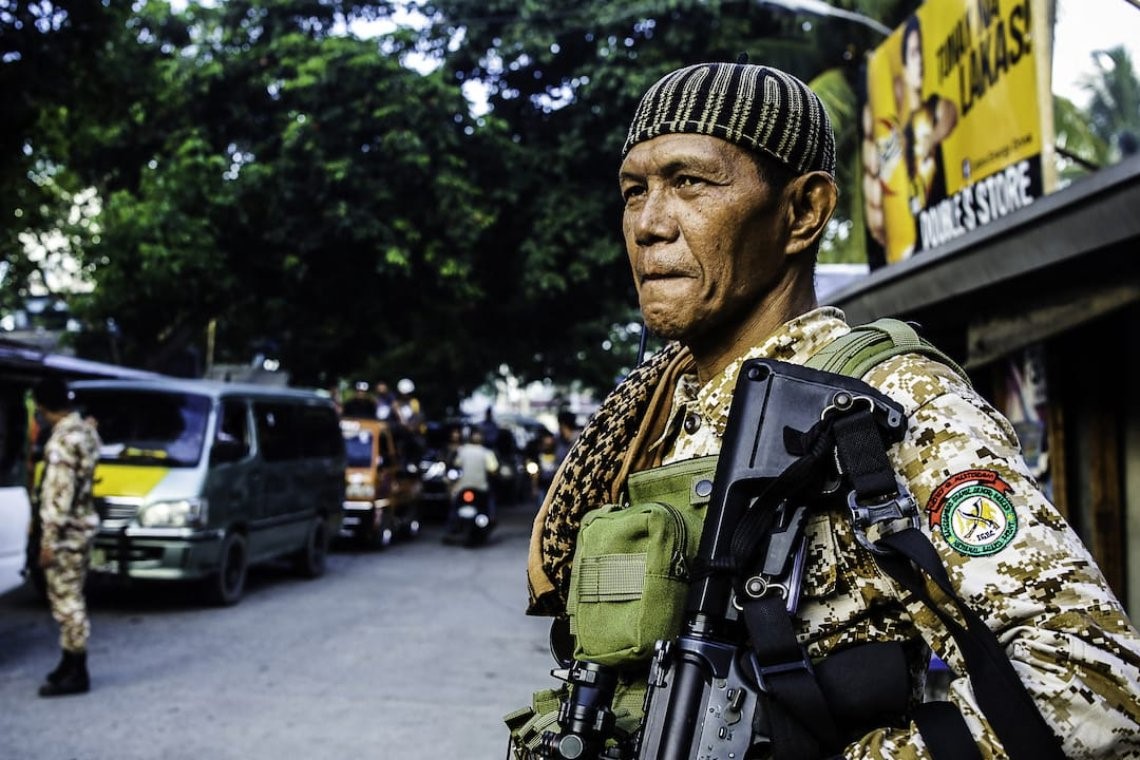 An armed security personnel patrols in the southern Philippines